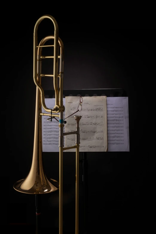 a trumpet sitting next to a sheet of music, by James Bard, museum piece, david kassan, 2010s, california;