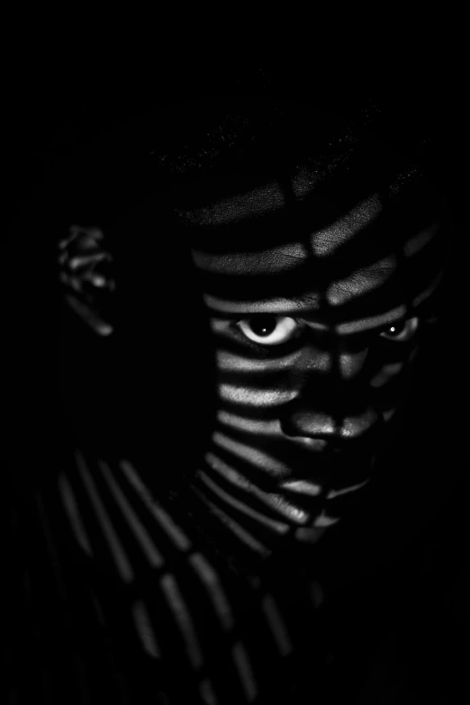 a black and white photo of a person in the dark, by Adam Marczyński, flickr, realism, striped, black skin!!!, high contrast shadows, trapped in my conscious