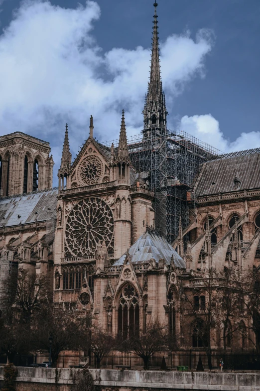 a large cathedral sitting next to a body of water, french architecture, burned city, 2022 photograph, gothic art style