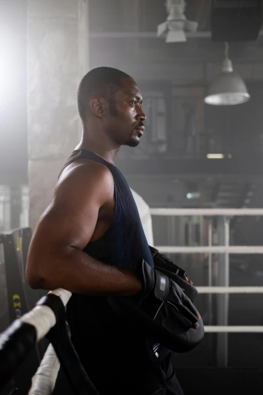 a man standing next to a boxing ring, inspired by Leonard Daniels, pexels contest winner, happening, in a gym, mkbhd as iron man, looking across the shoulder, virgil abloh