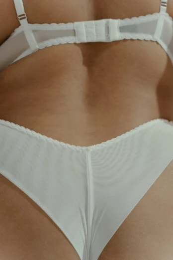 a close up of a person wearing underwear, white clothing, zoomed in, medium-shot, teasing