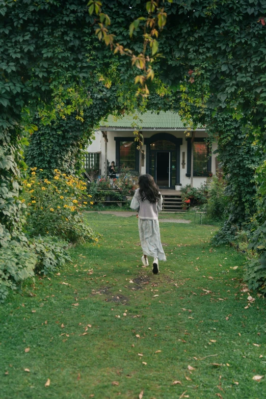 a little girl that is standing in the grass, a picture, inspired by Elsa Bleda, pexels contest winner, renaissance, beautiful house on a forest path, cottagecore!! fitness body, vine covered, people walking around