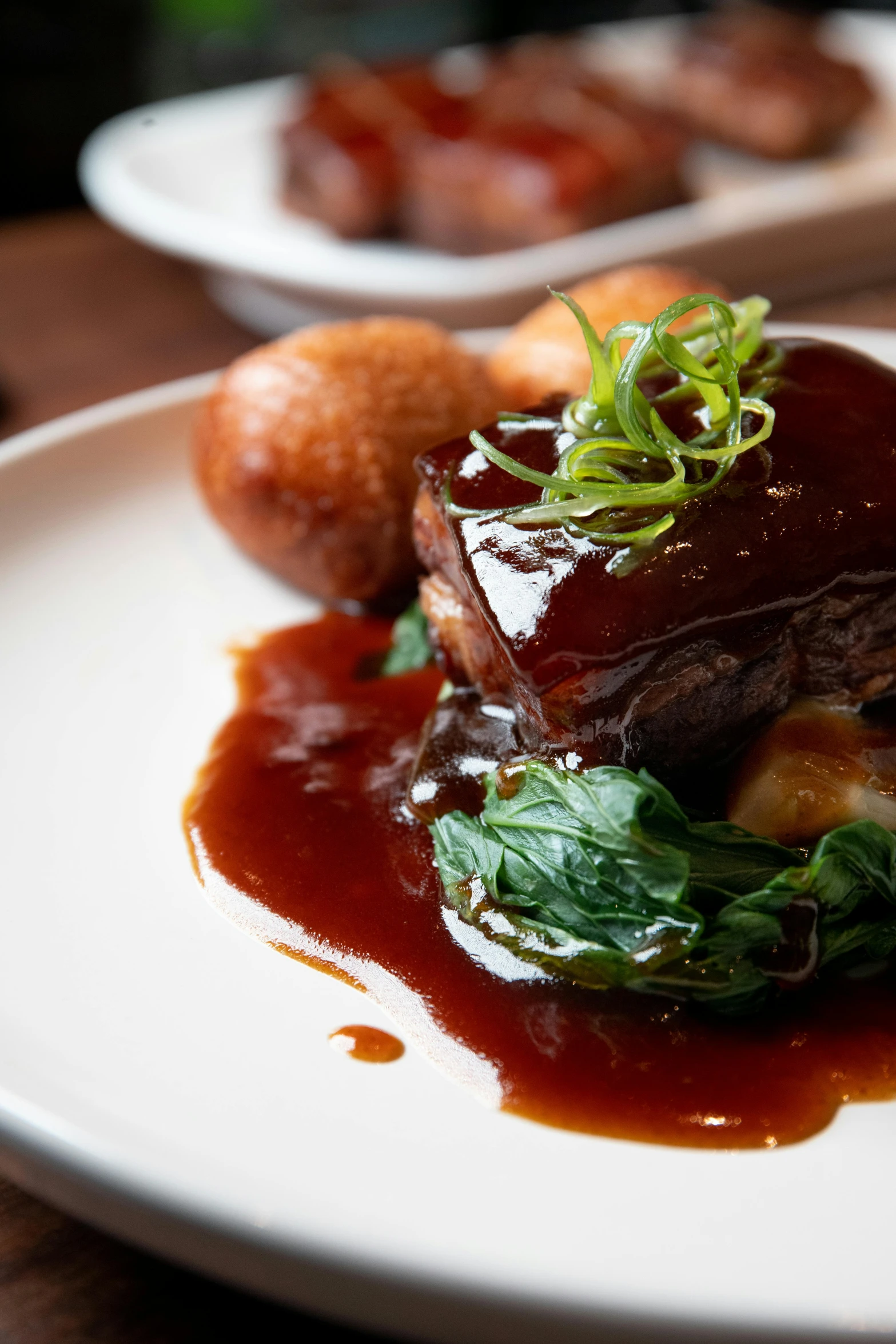 a white plate topped with meat covered in sauce, inspired by Richmond Barthé, unsplash, square, beams, mint, made of glazed