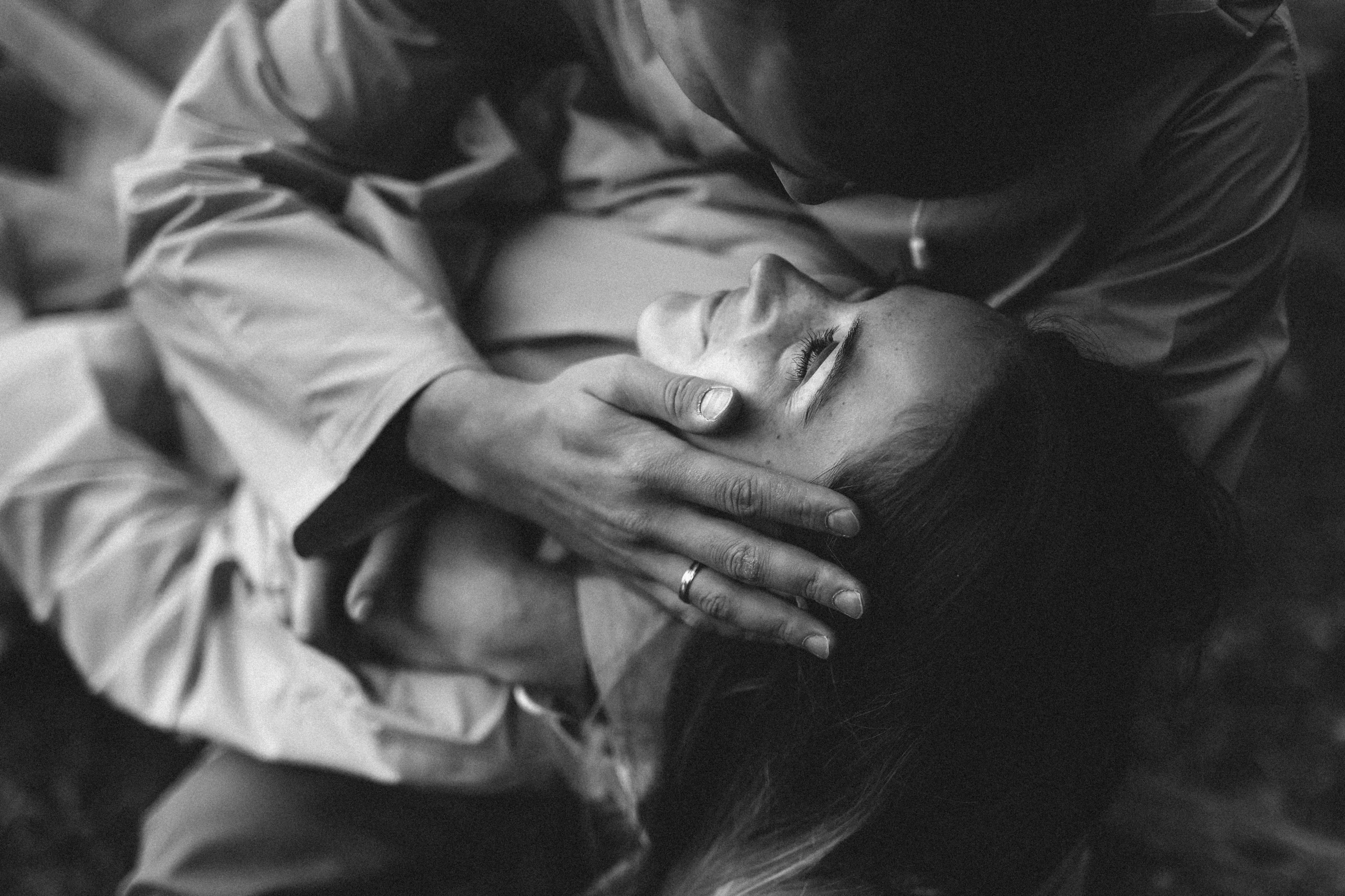 a black and white photo of a man hugging a woman, by Emma Andijewska, unsplash, renaissance, lying down, :: morning, high picture quality, anna nikonova