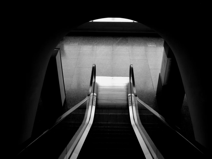 a black and white photo of an escalator, a black and white photo, pexels contest winner, minimalism, a portal to the depths, two in the void, instagram post, take off