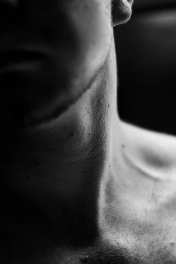 a black and white photo of a man in a car, a black and white photo, inspired by Peter Basch, unsplash, conceptual art, muscular neck, human skin texture, on a young beautiful woman neck, square masculine jaw