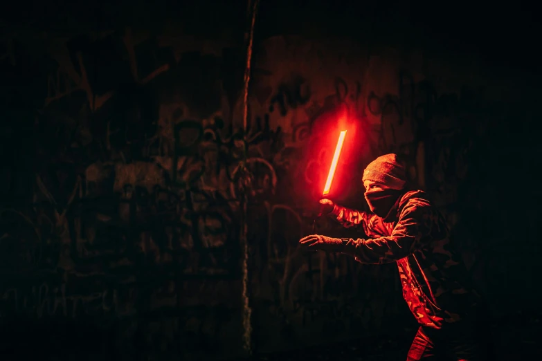 a person holding a light saber in a dark room, unsplash contest winner, graffiti, the red ninja, cinematic outfit photo, instagram photo, neon light showing injuries