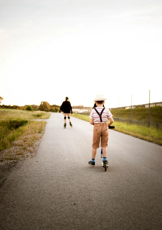 a couple of people riding skateboards down a road, by Jesper Knudsen, walking boy, half image, explore, 256435456k film