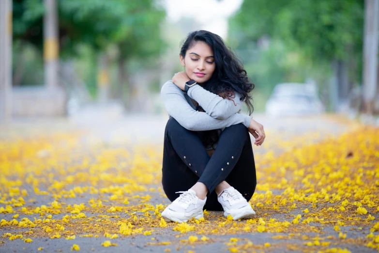 a woman sitting on the ground with her legs crossed, pexels contest winner, hurufiyya, avatar image, fall season, with a sad expression, handsome girl