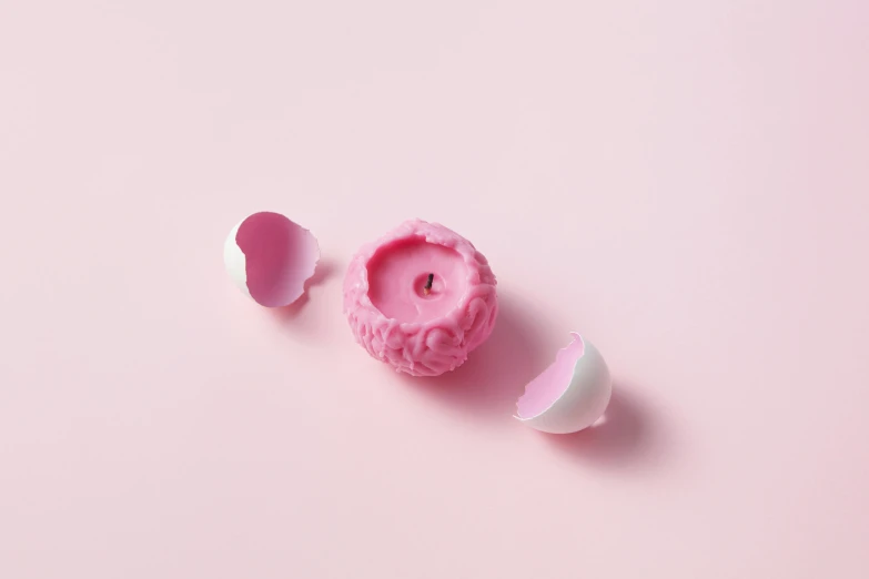 a pink doughnut and an egg shell on a pink background, inspired by Yanjun Cheng, trending on pexels, process art, on a candle holder, exploded view, 3 d print, viewed from behind