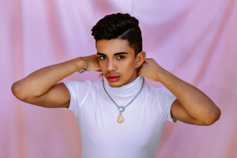 a man in a white shirt posing for a picture, an album cover, inspired by Carlos Berlanga, trending on pexels, les nabis, non binary model, wearing jewelry, middle eastern, teddy fresh