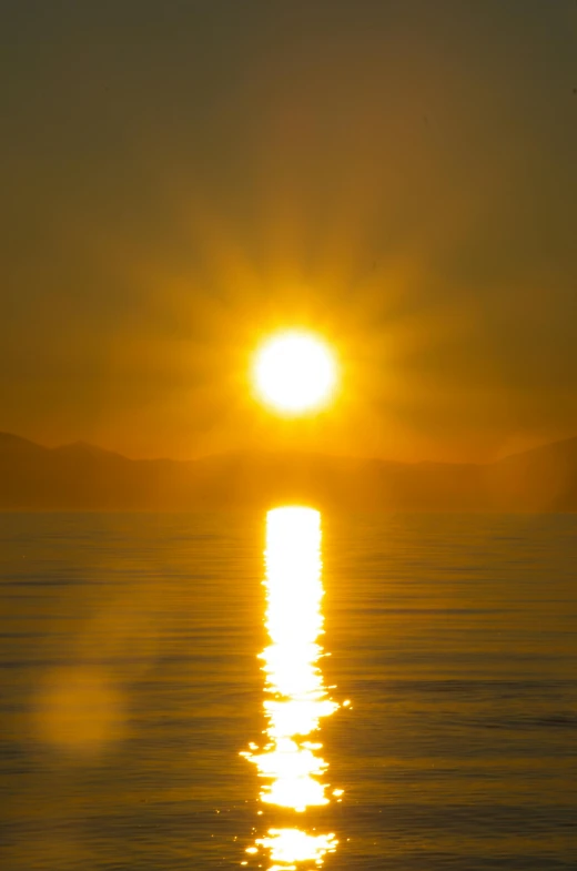 the sun is setting over a body of water, by Doug Ohlson, soft light - n 9, chile, toxic rays of the sun, shiny!!