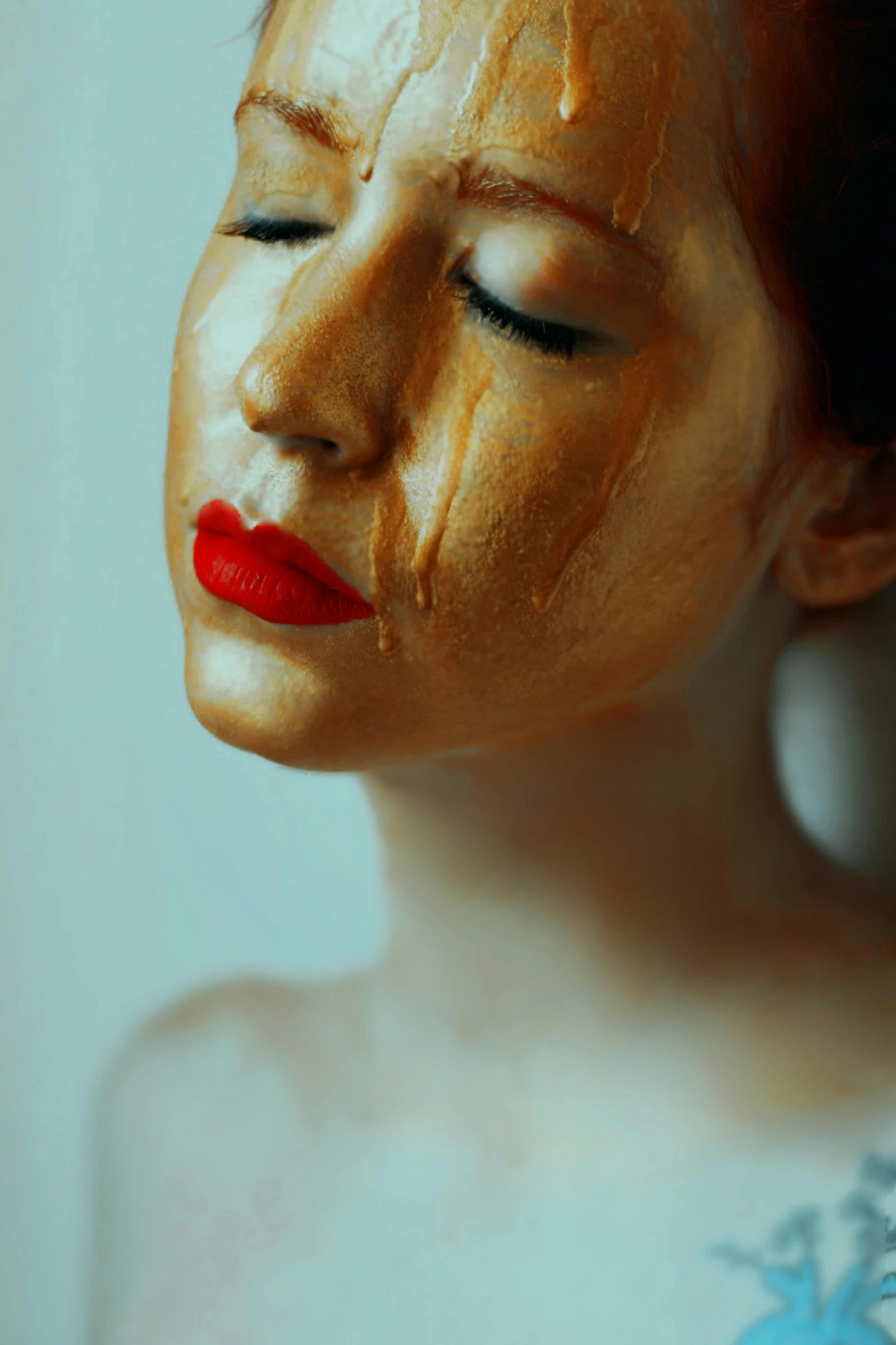 a close up of a woman with gold paint on her face, inspired by Elsa Bleda, trending on pexels, hyperrealism, woman crying, a redheaded young woman, sculpture of a woman, gold and red