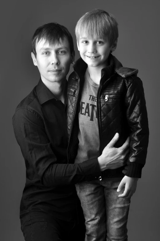 a black and white photo of a man and a boy, a black and white photo, by Ivan Grohar, studio!! portrait lighting, he is about 40 years old, in 2 0 1 2, ((portrait))