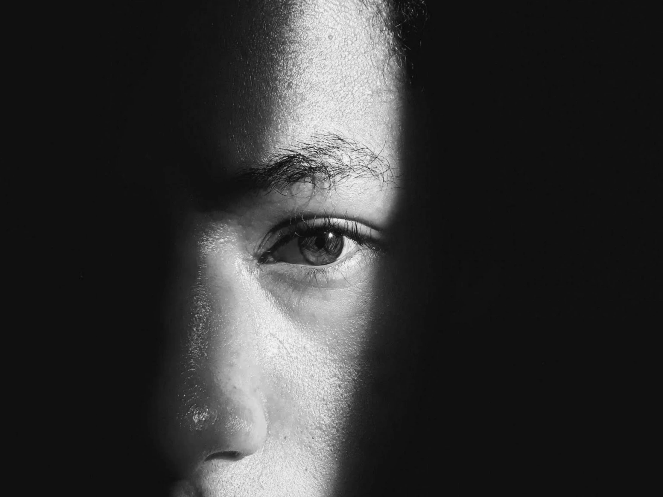 a black and white photo of a person's face, pexels, realistic. cheng yi, hiding, mixed-race woman, face is brightly lit