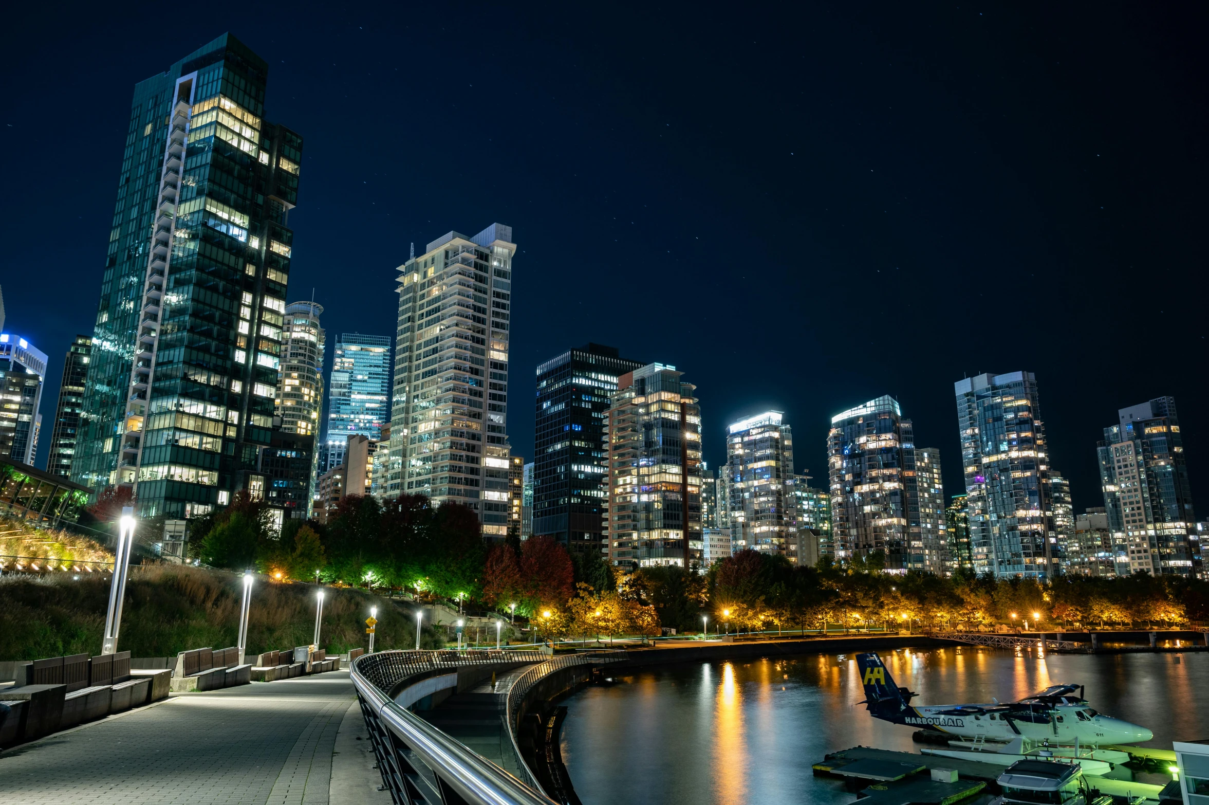 a body of water next to a city at night, pexels contest winner, vancouver school, all buildings on bridge, slide show, thumbnail, endless forest of high buildings