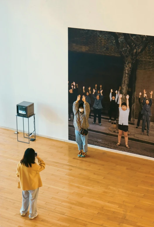 a couple of people that are standing in a room, inspired by Fei Danxu, unsplash, interactive art, helio oiticica, hangzhou, people watching around, 2022 photograph