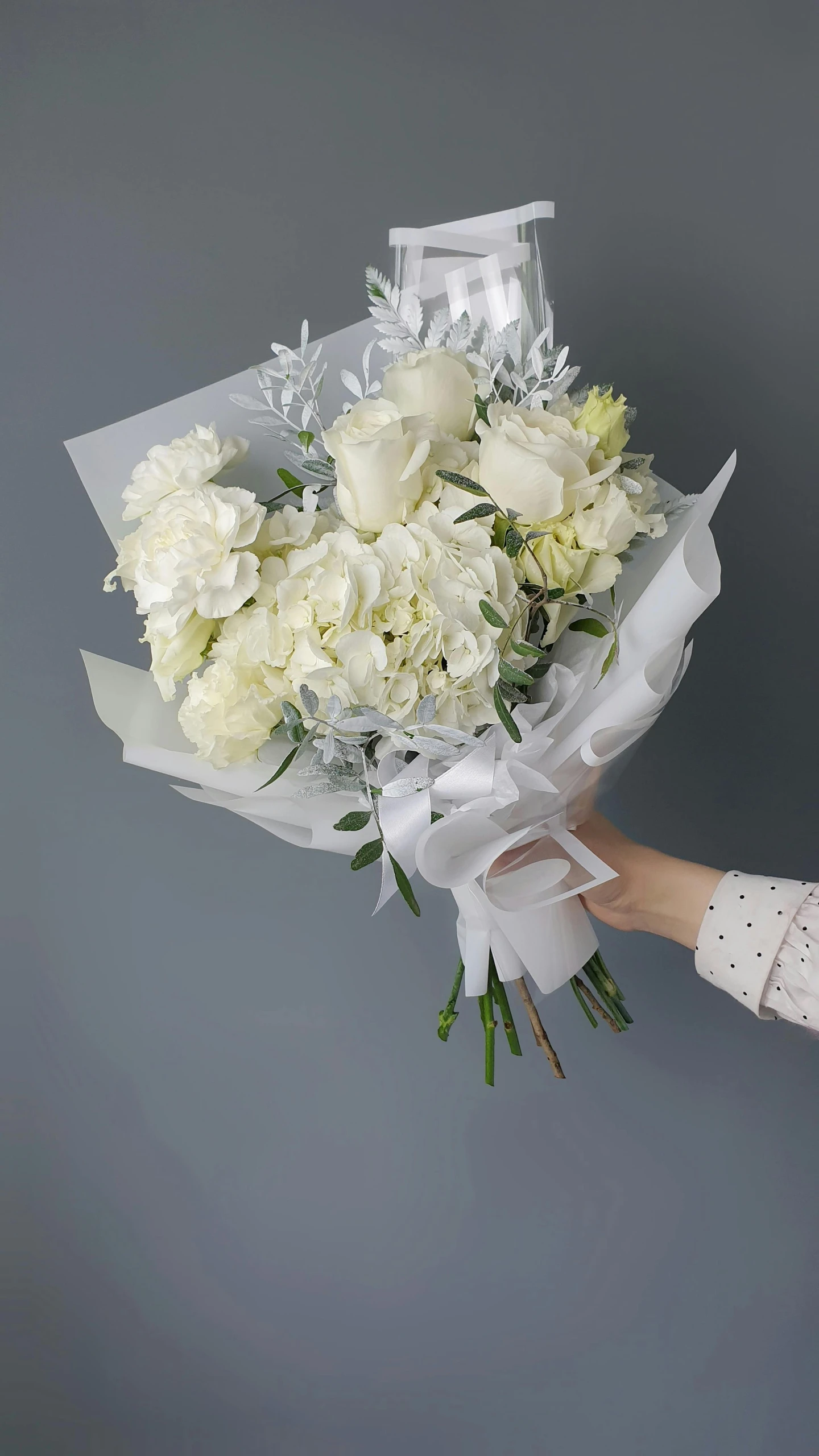 a woman holding a bouquet of white flowers, made in tones of white and grey, titanium white, hey buddy, on a gray background