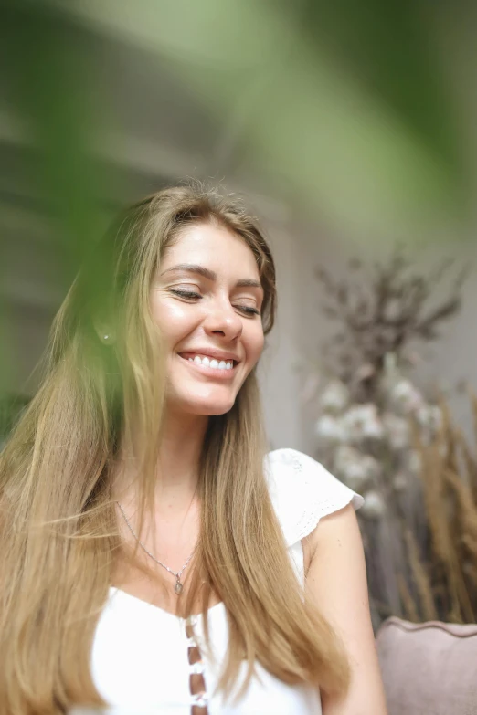 a beautiful young woman sitting on top of a couch, by Julia Pishtar, pexels contest winner, greenery, headshot profile picture, soft happy smile, soft light.4k