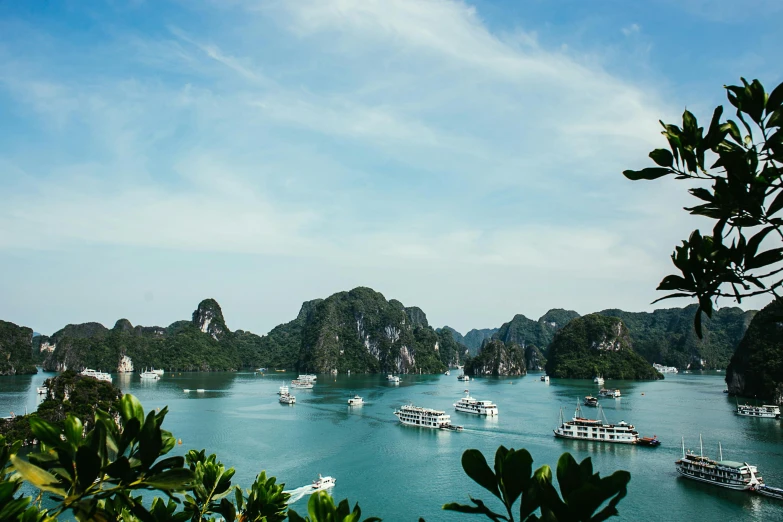 a large body of water filled with lots of boats, pexels contest winner, ao dai, thumbnail, hills and ocean, film photo