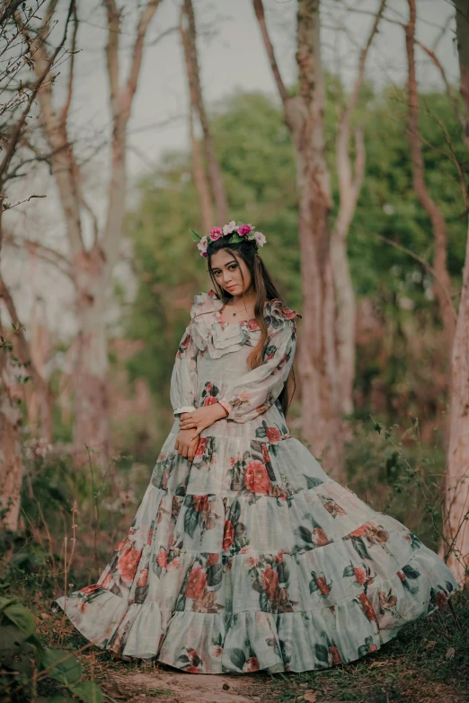 a woman in a floral dress standing in the woods, an album cover, inspired by reyna rochin, pexels contest winner, romanticism, indian style, traditional costume, grey, made of flowers