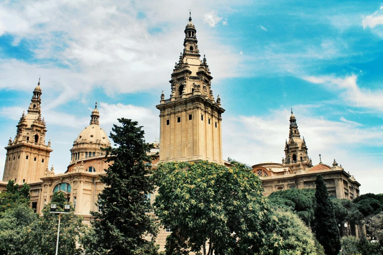 a large building with a clock tower on top of it, inspired by Tomàs Barceló, pexels contest winner, city buildings on top of trees, 1910s architecture, university, three views