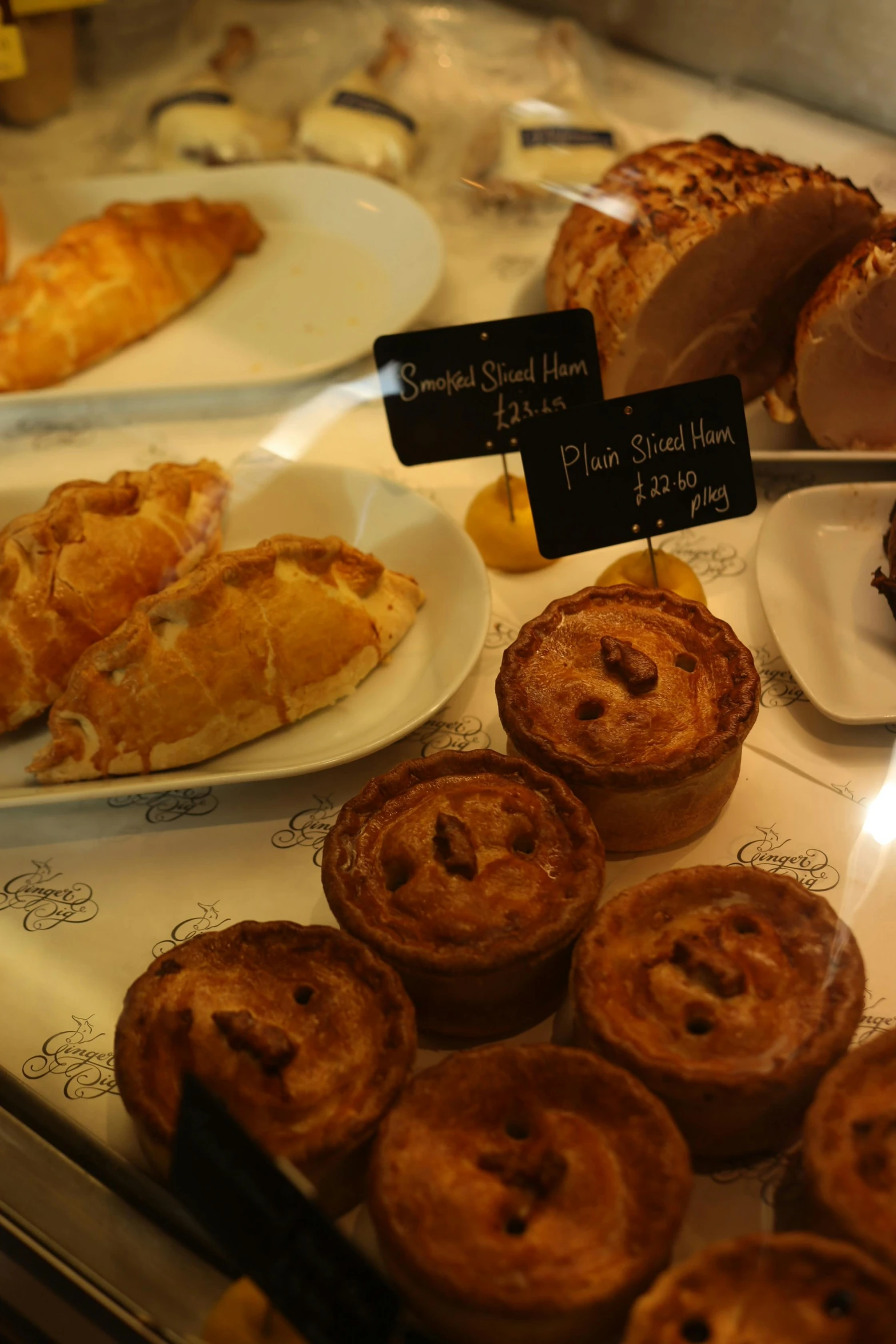 a display case filled with lots of pastries, a still life, inspired by Richmond Barthé, renaissance, calzone zone, thumbnail, scotland, close up shots