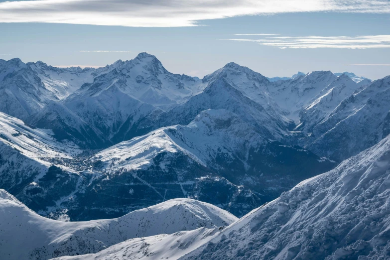 a group of people riding skis on top of a snow covered slope, by Cedric Peyravernay, pexels contest winner, les nabis, “ aerial view of a mountain, shades of blue and grey, with mountains in the distance, thumbnail