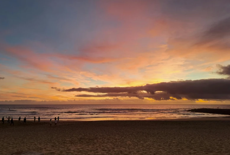 a group of people standing on top of a sandy beach, colourful sky, gold coast australia, profile image
