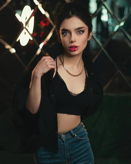 a woman posing for a picture in front of a fence, a colorized photo, inspired by Elsa Bleda, trending on pexels, taken in night club, young beautiful amouranth, cyber necklace, dark. studio lighting