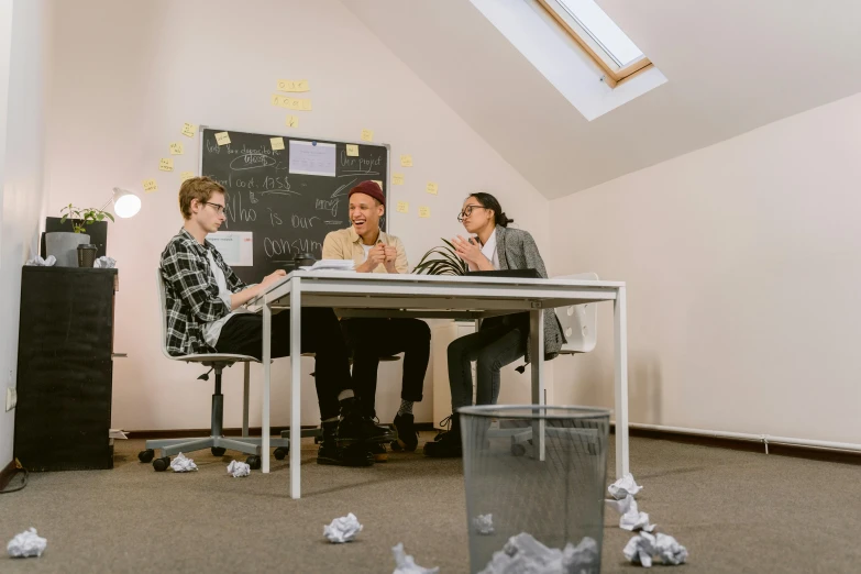 a group of people sitting at a table in a room, rubbish, profile image