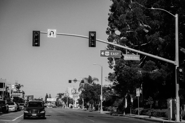 a black and white photo of a street with traffic lights, a black and white photo, renaissance, southern california, road street signs, fanart, christian cline