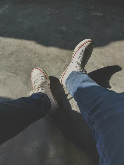 a person standing next to another person on a skateboard, inspired by Elsa Bleda, blue jeans and grey sneakers, profile image, wearing red converse shoes, chillin at the club together