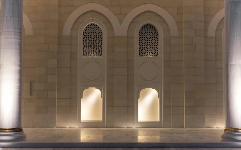 a couple of columns sitting next to each other, an ambient occlusion render, inspired by Osman Hamdi Bey, pexels contest winner, hurufiyya, windows lit up, oman, elegant walkways between towers, on a large marble wall