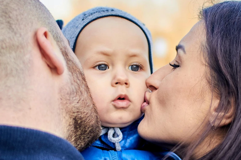 a close up of a person kissing a baby, husband wife and son, square, thumbnail, cute photo