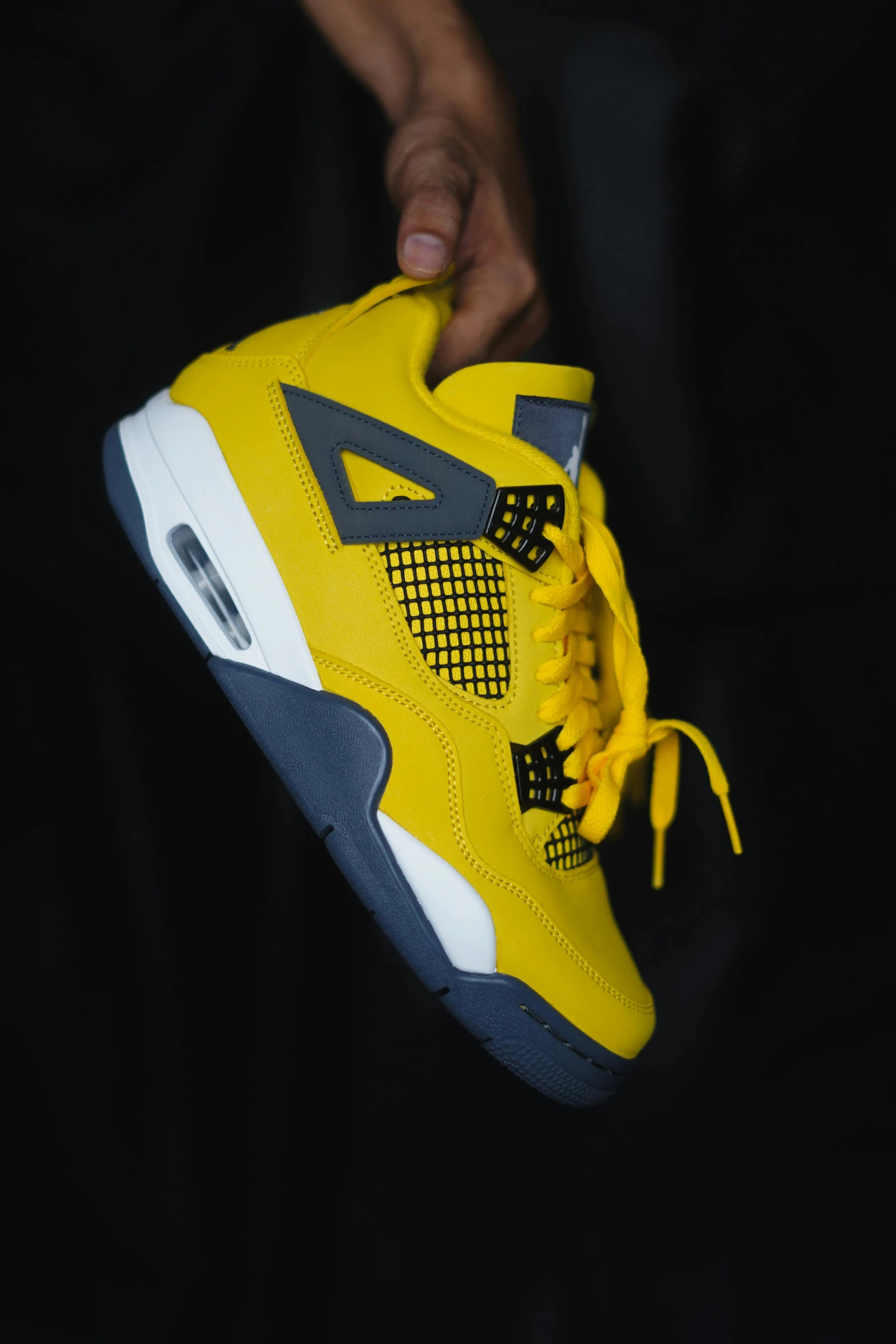 a person holding up a pair of sneakers, inspired by Jordan Grimmer, shades of yellow, slide show, nd 4, ap