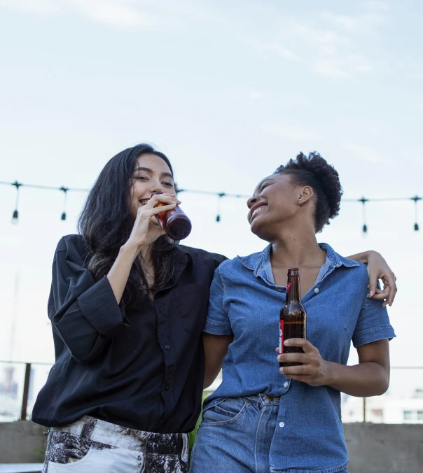 a couple of women standing next to each other, pexels, happening, drinking a bottle of coca-cola, rooftop party, kara walker james jean, drinking beer and laughing