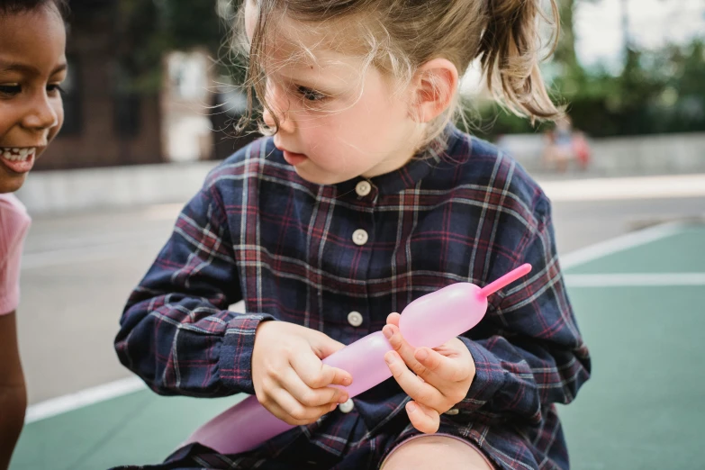 a couple of young girls sitting on top of a tennis court, a child's drawing, by Helen Stevenson, pexels contest winner, holding a small vape, pink shirt, purple checkerboard, closeup photograph