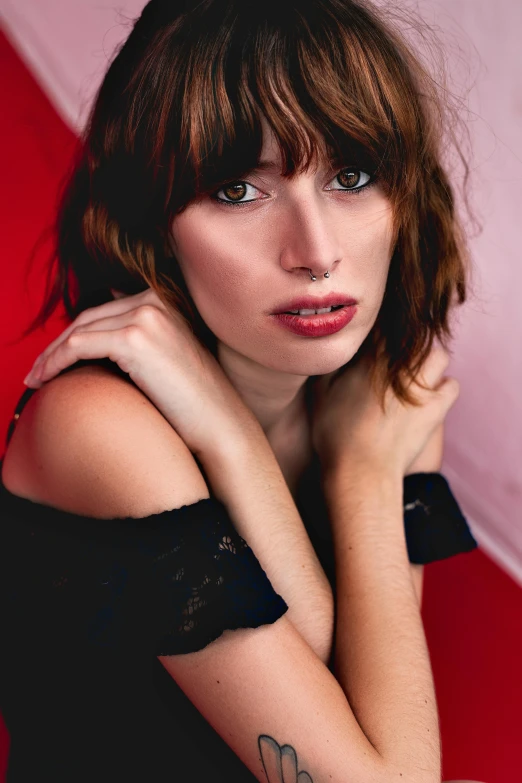 a woman with a tattoo on her arm, a portrait, inspired by Nan Goldin, trending on pexels, art nouveau, brown hair fringe, red bra, ana de armas portrait, medium format