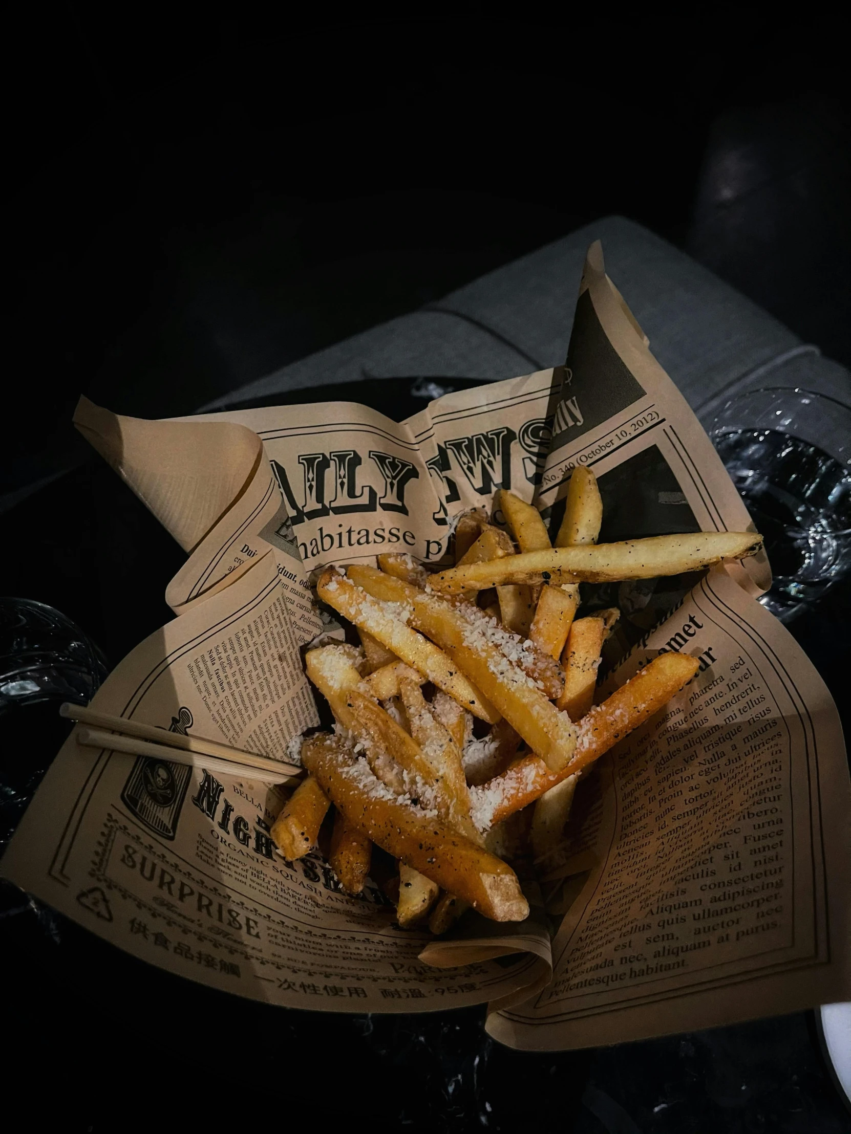 a basket of french fries sitting on top of a table, newspaper style, lit from the side, mini magic city, 🚿🗝📝