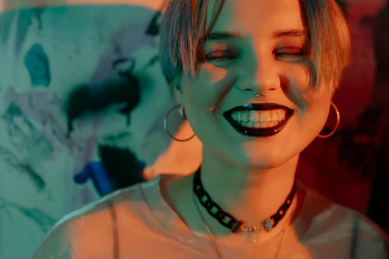 a close up of a person with a smile on their face, an album cover, inspired by Elsa Bleda, trending on pexels, graffiti, wearing black choker, dark neon punk, official music video, joey king