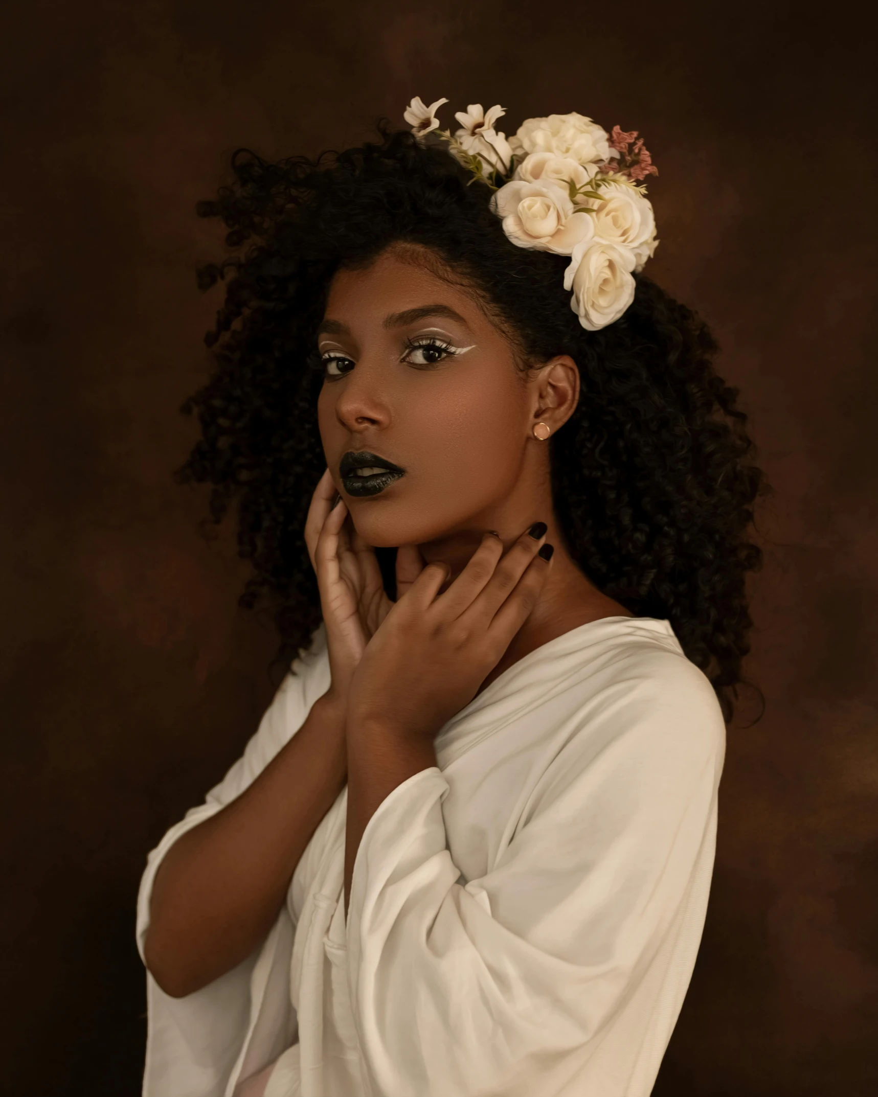 a woman with a flower in her hair, by Lily Delissa Joseph, trending on unsplash, renaissance, black lipstick, dark sienna and white, curls on top, modeling shoot