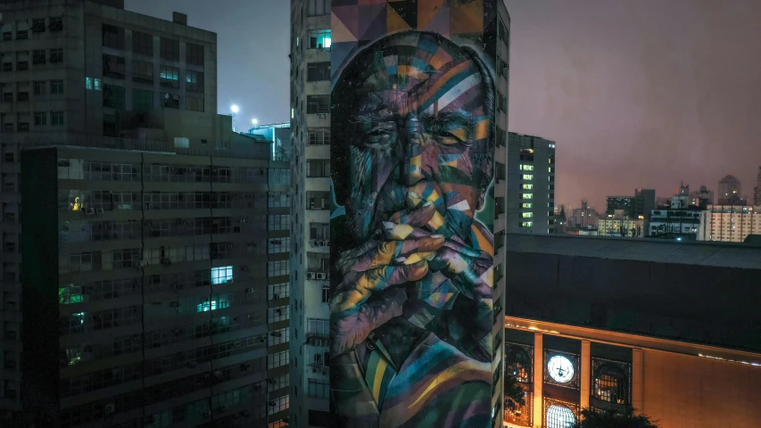 a painting on the side of a tall building, by NEVERCREW, pexels contest winner, smoking, peru, lit up, portrait of alan watts