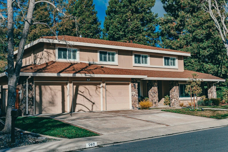 a house with a car parked in front of it, unsplash, cupertino, background image, 70s photo, high resolution photo