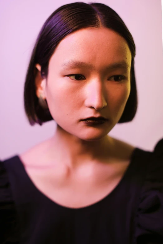 a close up of a person with a cell phone, an album cover, inspired by Taro Yamamoto, realism, black dress : : symmetrical face, dark moody purple lighting, mei-ling zhou, nonbinary model