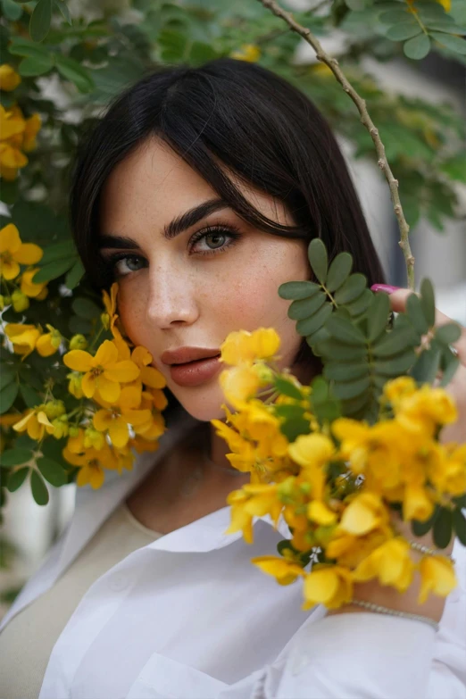 a woman holding a bunch of yellow flowers, by irakli nadar, trending on pexels, ana de armas portrait, with soft bushes, arab ameera al taweel, shady look