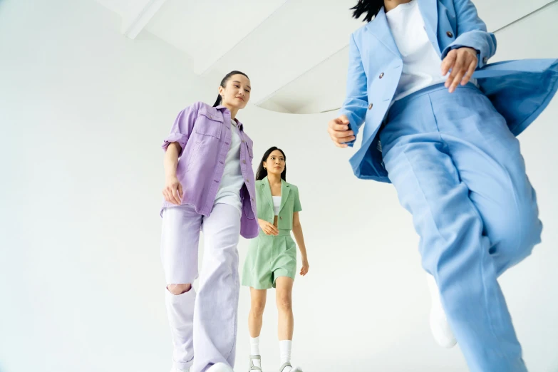 a group of people standing next to each other, trending on pexels, issey miyake, mauve and cyan, women full body, 3 - piece