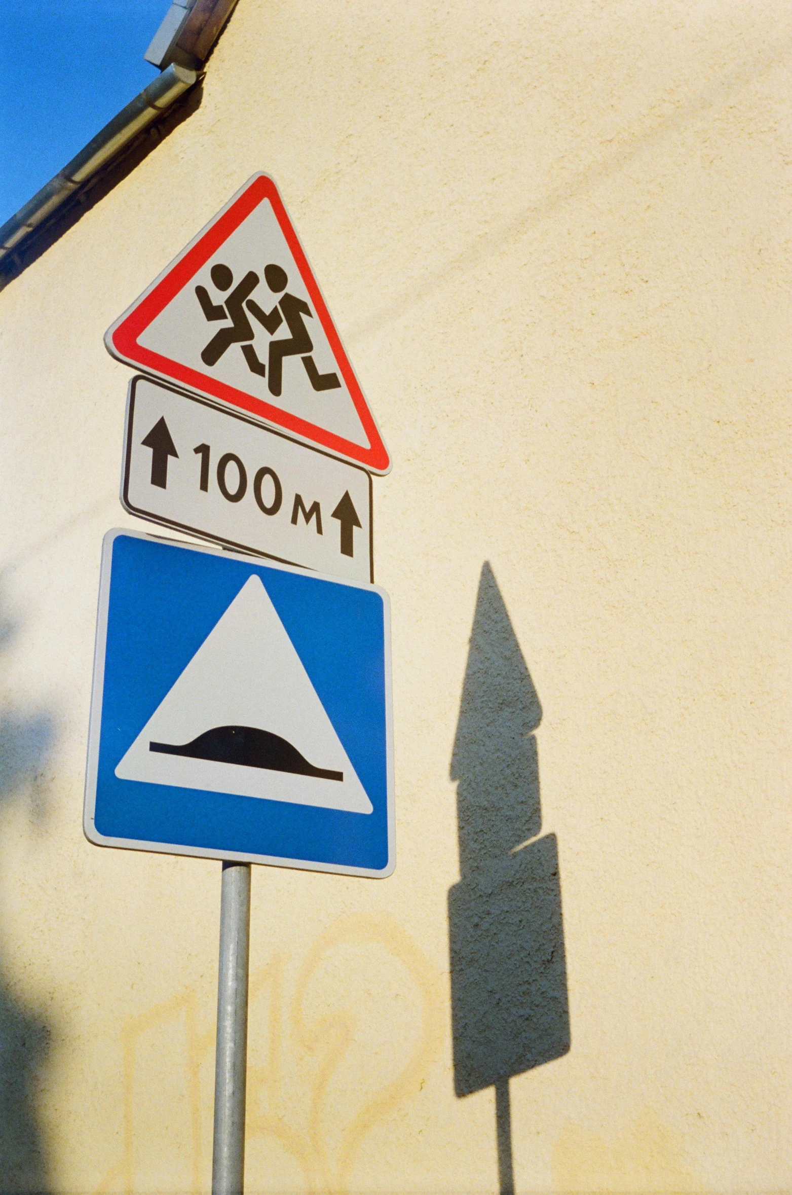 a close up of a street sign with a building in the background, simin stalenhag, be running up that hill, pictogram, 1 0 0 meter in the distance