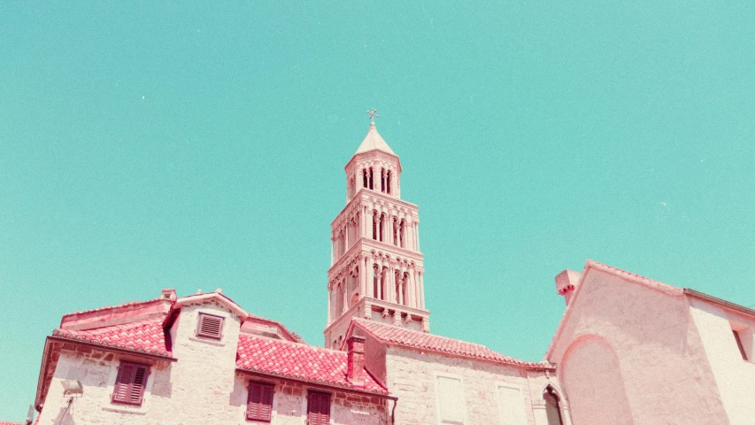 a building with a clock tower on top of it, a picture, by Lubin Baugin, unsplash contest winner, romanesque, pink white turquoise, color film photography 1970s, cathedral of sun, split near the left