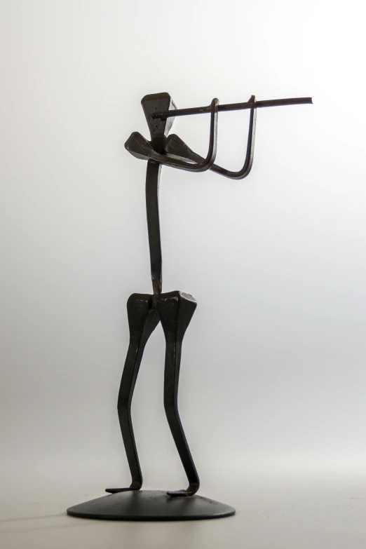a sculpture of a man playing a trumpet, inspired by Diego Giacometti, ebony wood bow, long legs, hanging, wrench